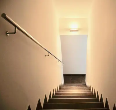a stairway with a hand rail and a stair case at Residential Tourist Apartments in Caldes d'Estrac