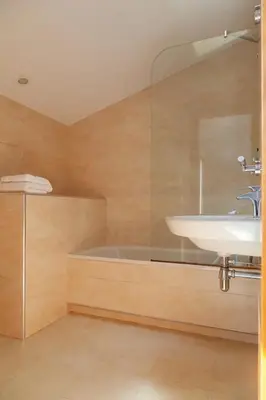 a bathroom with a sink and a bath tub at Residential Tourist Apartments in Caldes d'Estrac
