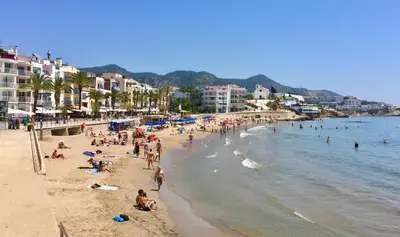 a group of people on a beach in the water at Heart of Sitges in Sitges
