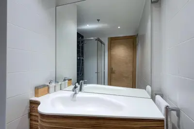 a bathroom with a white sink and a mirror at Plaza Europa Fira Gran Via in Hospitalet de Llobregat