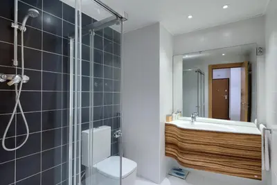 a bathroom with a shower and a toilet and a sink at Plaza Europa Fira Gran Via in Hospitalet de Llobregat