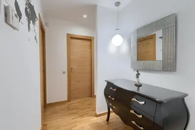 a black dresser in a room with a door at Plaza Europa Fira Gran Via in Hospitalet de Llobregat