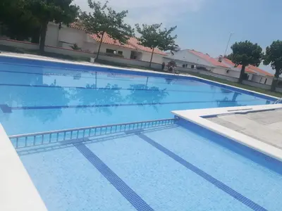 a large swimming pool with blue water at Sitges - Apartamento in Sitges