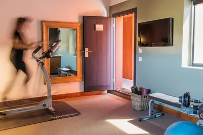 a room with a gym with a treadmill and a mirror at Primero Primera in Barcelona
