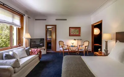 a living room with a bed and a couch and a table at Primero Primera in Barcelona