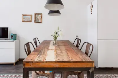 a dining room with a wooden table and chairs at Stylish Apartment with Terrace for Couple or Family in Barcelona