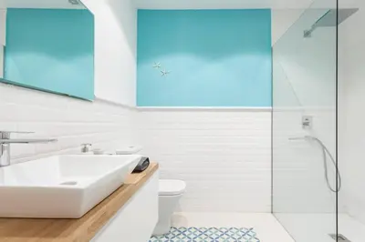 a bathroom with a sink and a glass shower at Stylish Apartment with Terrace for Couple or Family in Barcelona