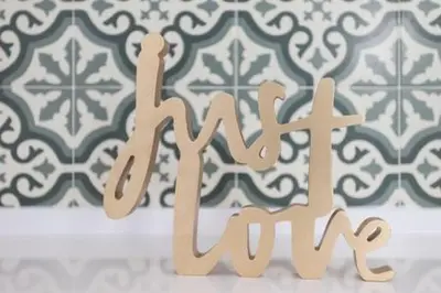 a wooden sign that says mum in front of a wall at Stylish Apartment with Terrace for Couple or Family in Barcelona