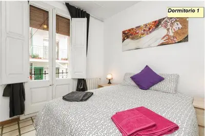 a bedroom with a bed with two towels on it at Apartamento Joel in Barcelona