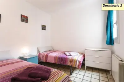 a bedroom with two beds and a dresser at Apartamento Joel in Barcelona