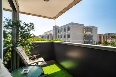 a balcony with a table and a view of a city at Forum Beach in Sant Adria de Besos