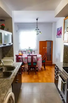 a kitchen and dining room with a table and chairs at Forum Beach in Sant Adria de Besos