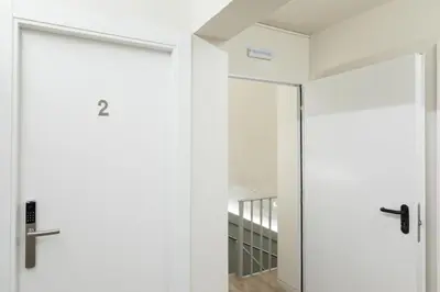 a pivot door in a room with white walls at Hostal Oliveta in Barcelona
