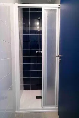 a shower with a glass door in a bathroom at Sea Hostel Barcelona in Barcelona