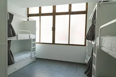a room with two bunk beds and a window at Sea Hostel Barcelona in Barcelona
