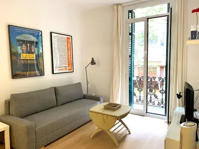a living room with a couch and a table at Apartments Gaudi Barcelona in Barcelona