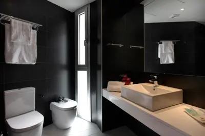 a bathroom with a white toilet and a sink at Fisa Rentals Les Corts Apartments in Barcelona