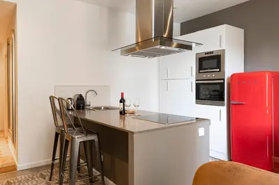 a kitchen with a red refrigerator and a counter at Central Suites Barcelona in Barcelona