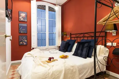 a bedroom with a bed with a bowl of fruit on it at Central Suites Barcelona in Barcelona