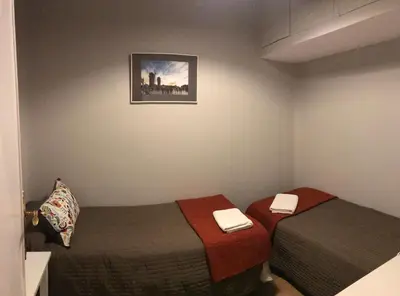 a room with two beds and a picture on the wall at Casa Consell Apartments in Barcelona