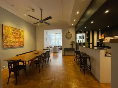 a dining room and kitchen with a table and chairs at Casa Consell Apartments in Barcelona