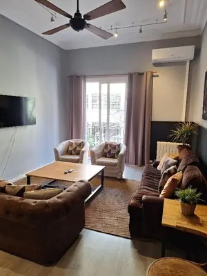 a living room with two couches and a table at Casa Consell Apartments in Barcelona