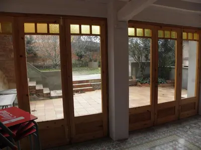 two french doors in a room with a patio at Hostal Cal Pla in Sant Llorenc Savall