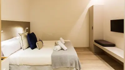 a bedroom with a bed with towels on it at Fisa Rentals Ramblas Apartments in Barcelona