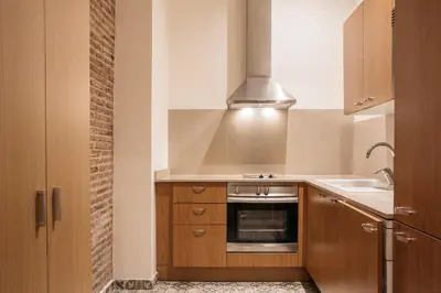 a kitchen with a sink and a stove top oven at Wello Apartments in Barcelona