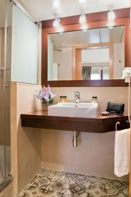 a bathroom with a sink and a mirror at Wello Apartments in Barcelona