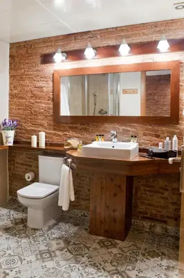 a bathroom with a sink and a toilet and a mirror at Wello Apartments in Barcelona