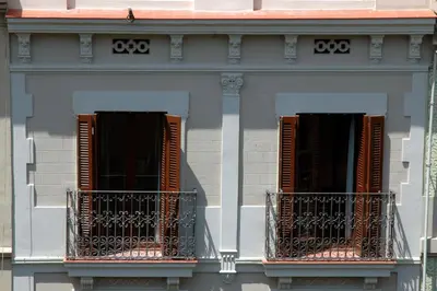 two windows on the side of a building at Wello Apartments in Barcelona
