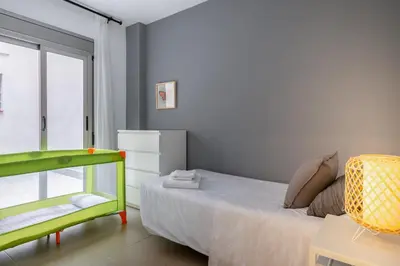 a small bedroom with a bed and a window at Inside Barcelona Apartments Salva in Barcelona