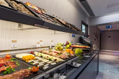 a buffet line with many different types of food at Ikonik Ramblas in Barcelona