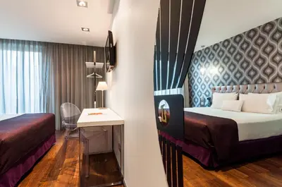 a hotel room with a bed and a table at Ikonik Ramblas in Barcelona