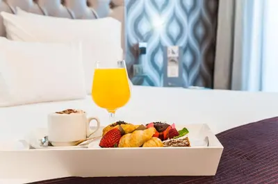 a tray of food and a glass of orange juice at Ikonik Ramblas in Barcelona