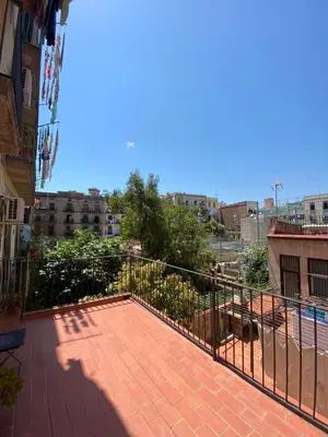 a balcony of a building with a fence at Hostal Drassanes in Barcelona