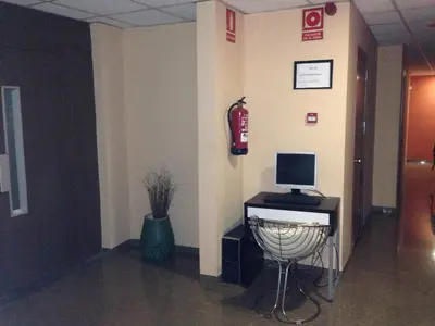 a hallway with a fire hydrant and a computer on a wall at Hostal Drassanes in Barcelona