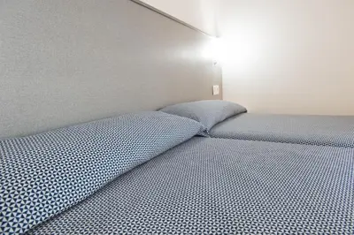 a bed with a polka dot mattress in a room at Hostal Drassanes in Barcelona