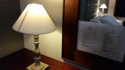a lamp sitting on a table next to a mirror at Hostal LK Barcelona in Barcelona