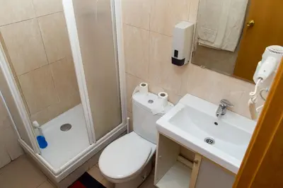 a bathroom with a toilet and a sink and a shower at Hostal LK Barcelona in Barcelona