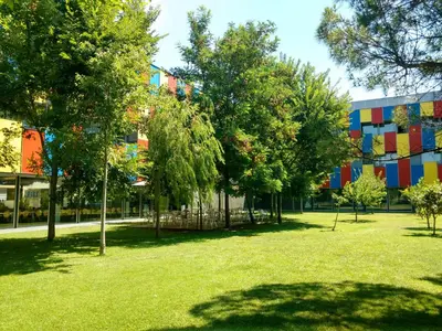 a park with trees in front of a building at Centre Esplai Albergue in El Prat de Llobregat