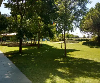 a park with trees in the middle of a field at Centre Esplai Albergue in El Prat de Llobregat