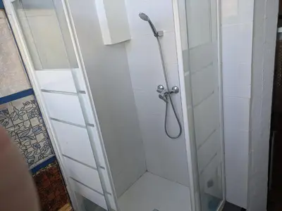 a shower with a glass door in a bathroom at Pension Casa De Barca in Barcelona