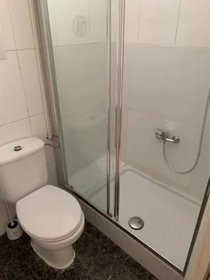 a bathroom with a toilet and a shower at YOUTH HOSTEL - Central and Basic Drassanes in Barcelona