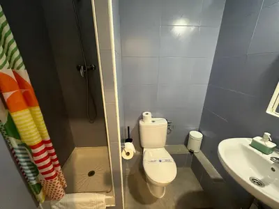 a small bathroom with a toilet and a sink at YOUTH HOSTEL - Central and Basic Drassanes in Barcelona