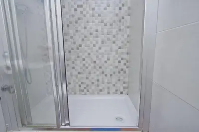 a shower with a glass door in a bathroom at Barcelona City Rooms Hostal in Barcelona