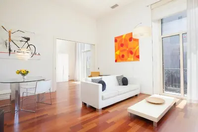 a living room with a white couch and a table at Akira Flats Plaza Catalunya Centric apartments in Barcelona