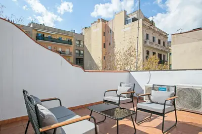 a balcony with chairs and a table on a building at Alcam Studio Alio3 in Barcelona