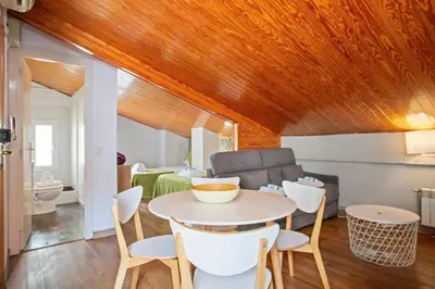 a room with a table and chairs and a couch at Alcam Studio Alio3 in Barcelona